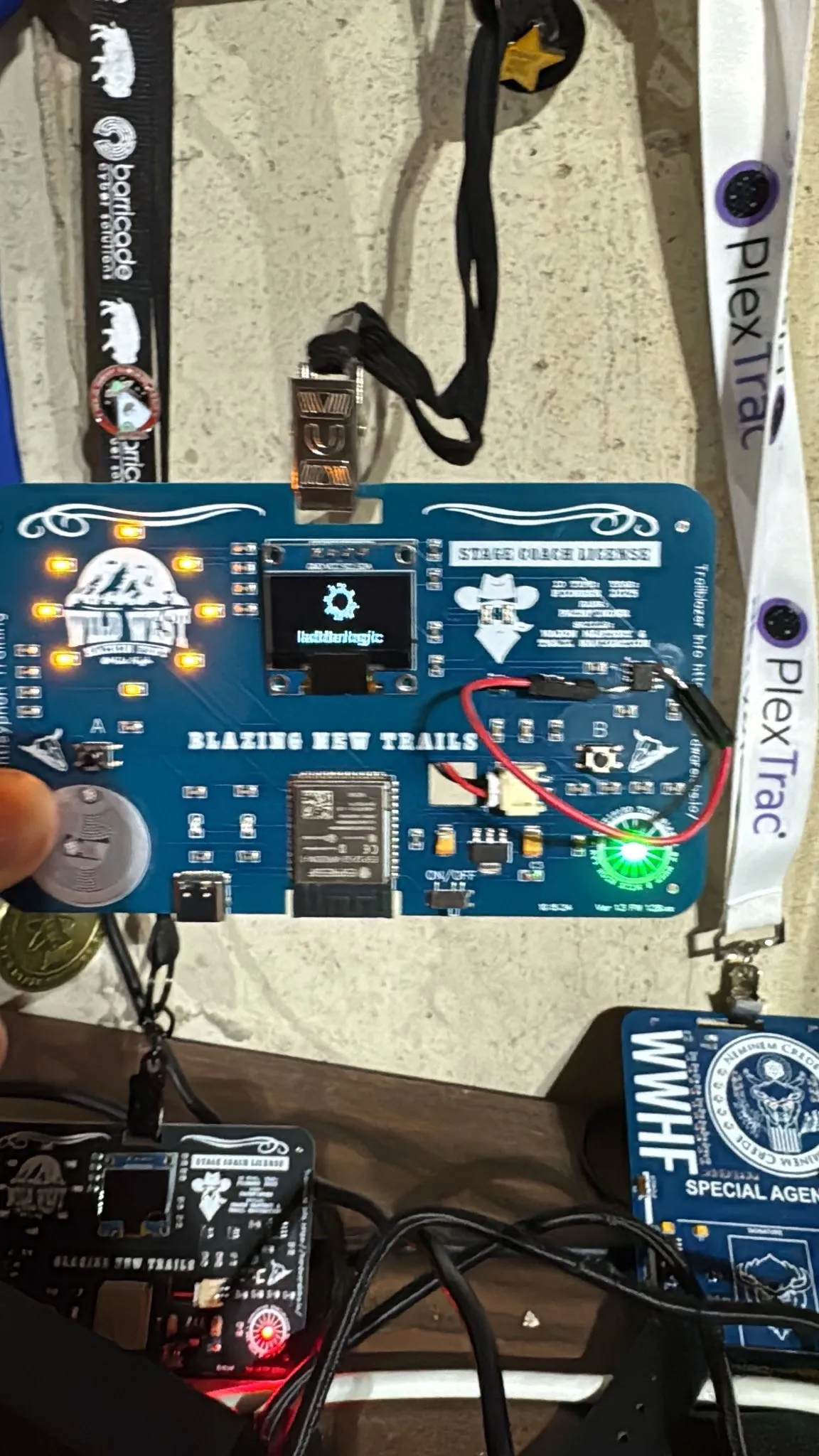Mile High badge running custom firmware with its LEDs lit